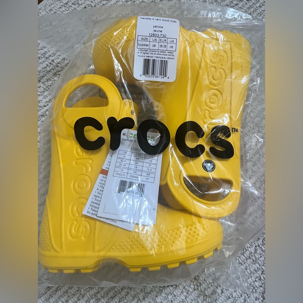 Brand new bright yellow kids crocs rain boots. Toddler size 9